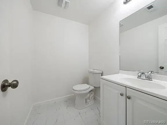 a bathroom with a sink toilet and a mirror