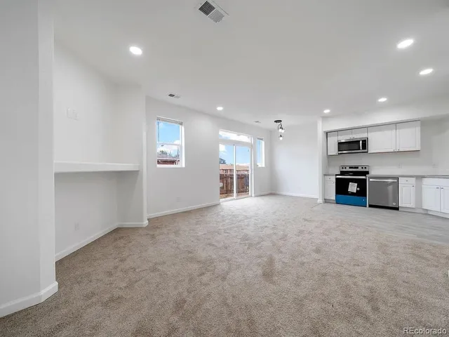 a view of kitchen with kitchen island a sink stainless steel appliances and cabinets