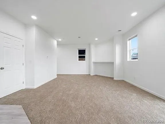 an empty room with a empty space and windows