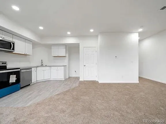 a view of a kitchen with microwave and cabinets