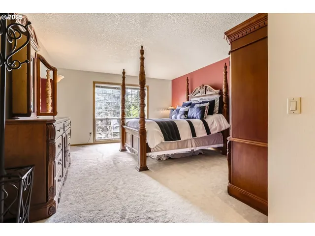 a view of a bedroom with furniture and a chandelier