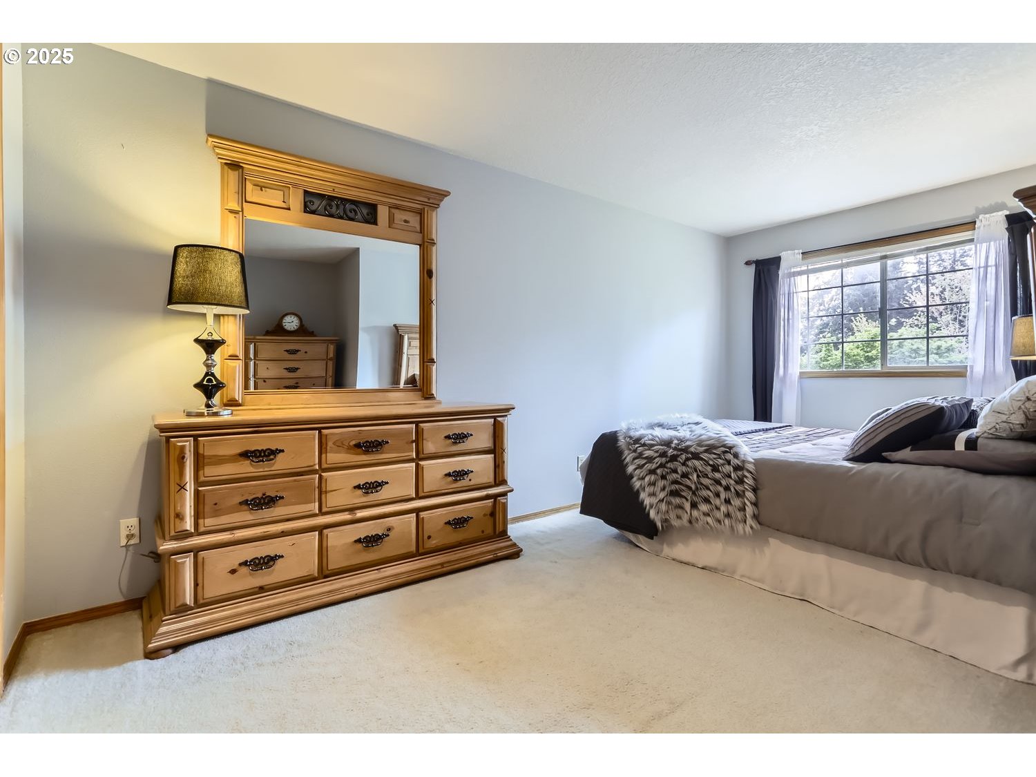 14525 Southwest Chesterfield Lane Portland, OR 97224 - Photo 20 of 31 a bedroom with a bed and a dresser
