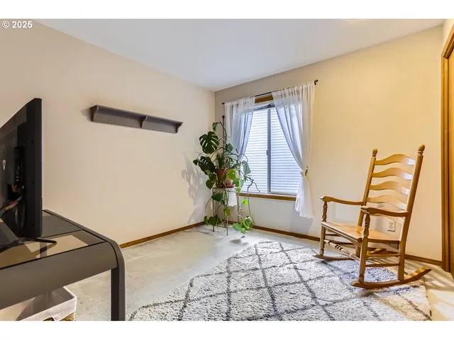 a bathroom with a granite countertop sink mirror vanity and toilet