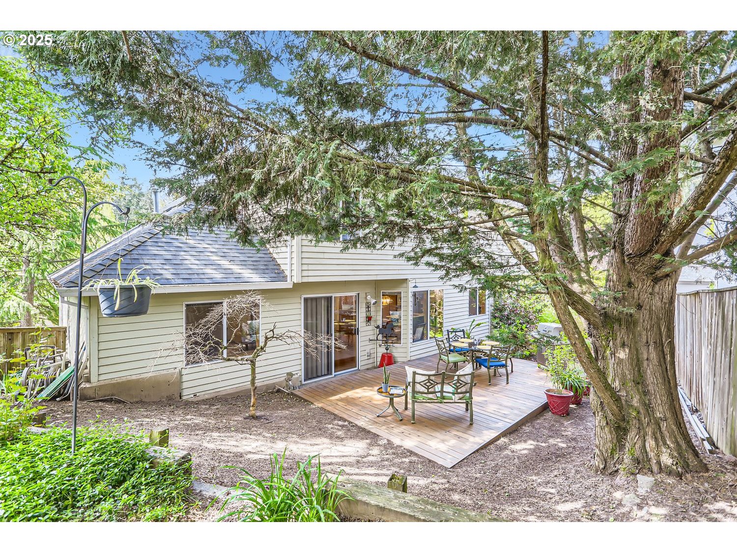 14525 Southwest Chesterfield Lane Portland, OR 97224 - Photo 25 of 31 a backyard of a house with table and chairs