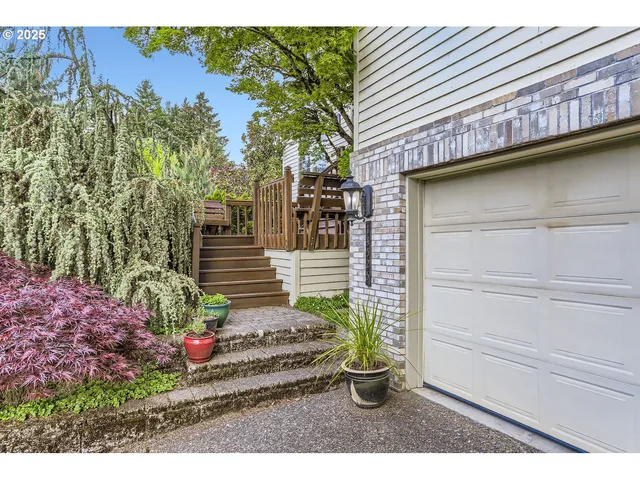 a view of a house with a yard and potted plants