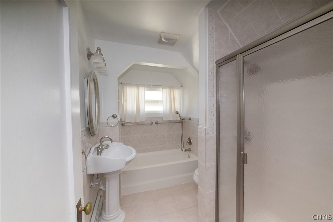 167 Beverly Road Syracuse, NY 13207 - Photo 27 of 50 A pedestal sink, tiled flooring, and a glass-enclosed shower stall complete this functional bathroom layout.