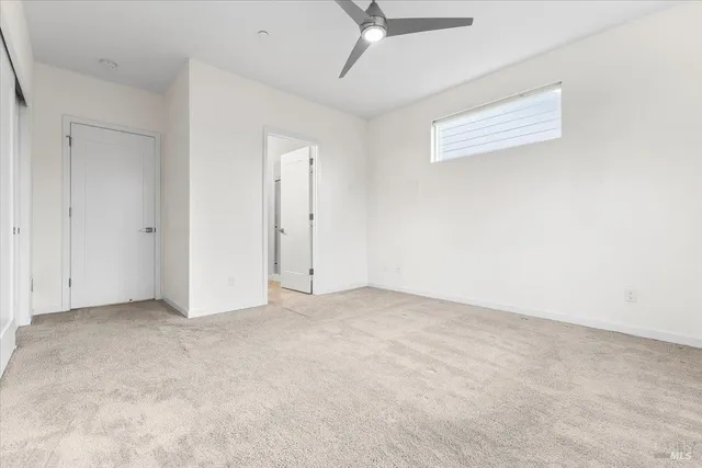 an empty room with a ceiling fan