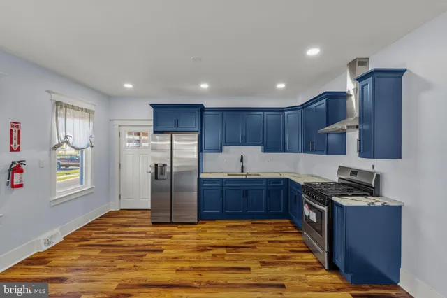 a kitchen with stainless steel appliances granite countertop a refrigerator sink and cabinets
