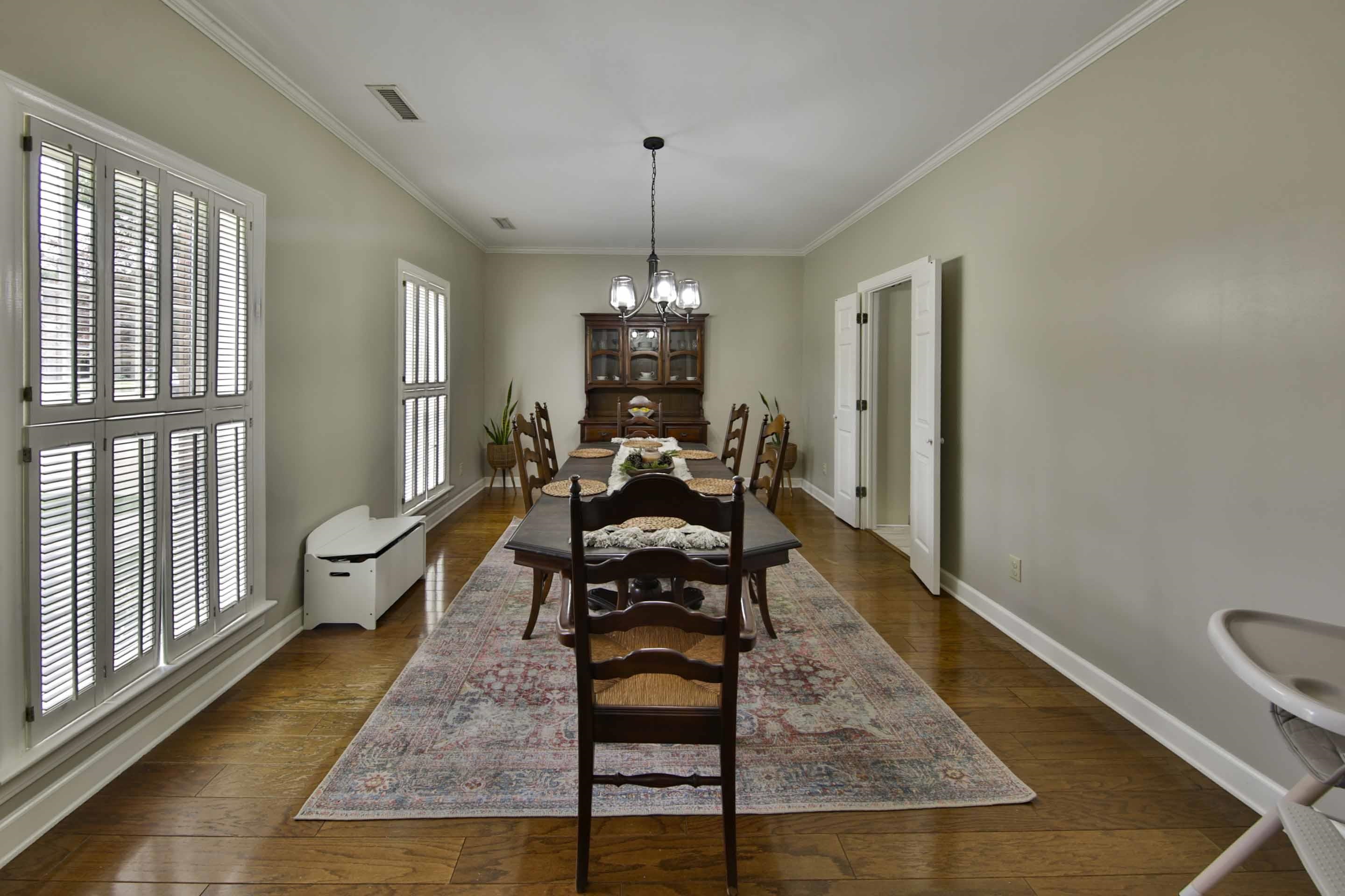104 Miller Road Covington, TN 38019 - Photo 16 of 25 Elongated dining space featuring wood-finish flooring, plantation shutters, and crown molding