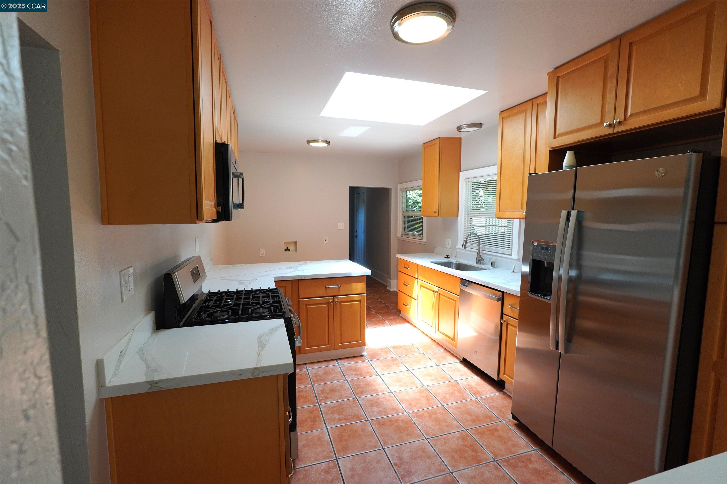 2645 Maxwell Avenue Oakland, CA 94619 - Photo 12 of 19 a kitchen with a refrigerator and a sink