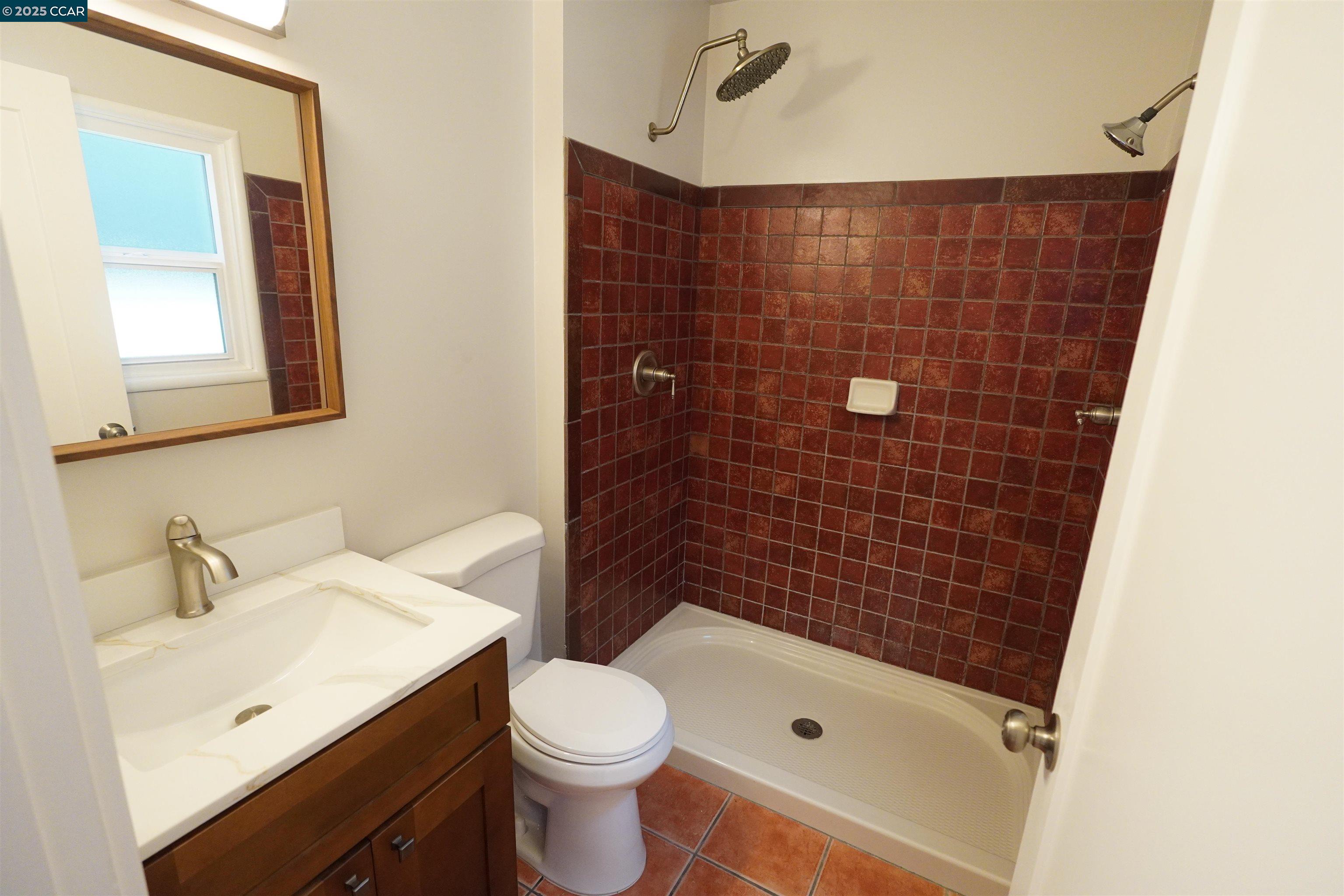 2645 Maxwell Avenue Oakland, CA 94619 - Photo 13 of 19 a bathroom with a sink a toilet and shower