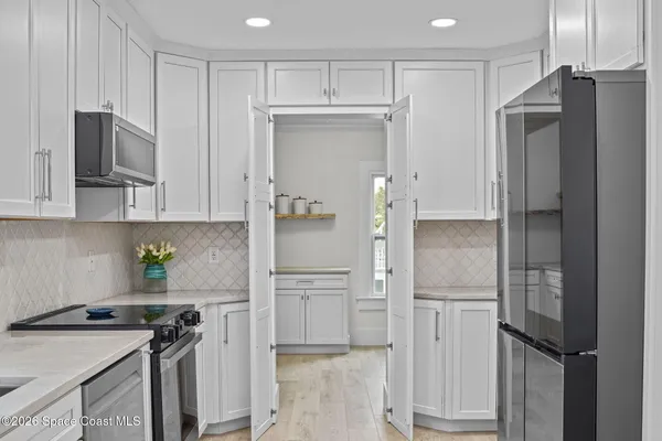 a kitchen with stainless steel appliances a stove microwave and refrigerator