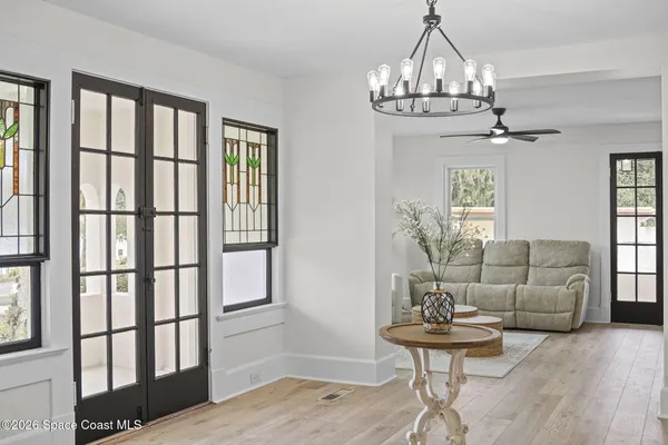 a view of a bedroom with furniture and floor to ceiling window