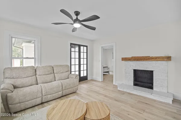 a spacious bedroom with furniture and a large window