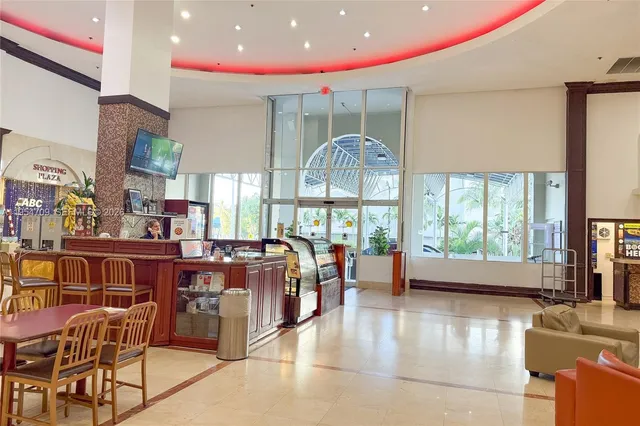 a lobby with furniture and a potted plant