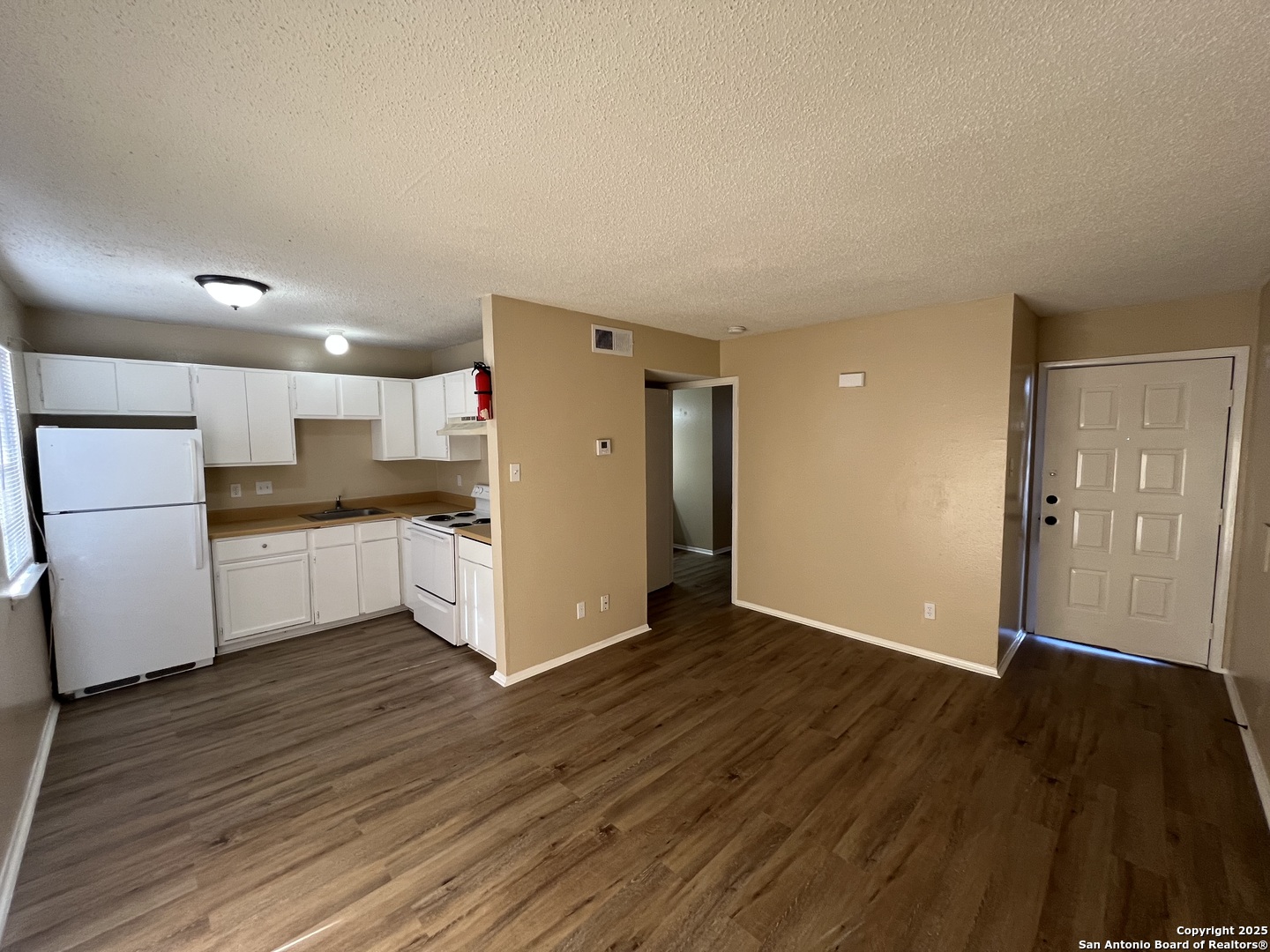 300 Moursund Boulevard, Unit 9 San Antonio, TX 78221 - Photo 2 of 10 a view of kitchen with refrigerator and wooden floor