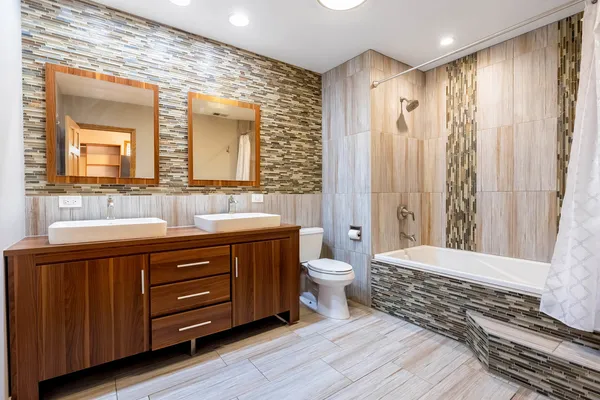a bathroom with a double vanity sink a toilet and a mirror