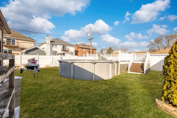 a swimming pool with outdoor seating and yard