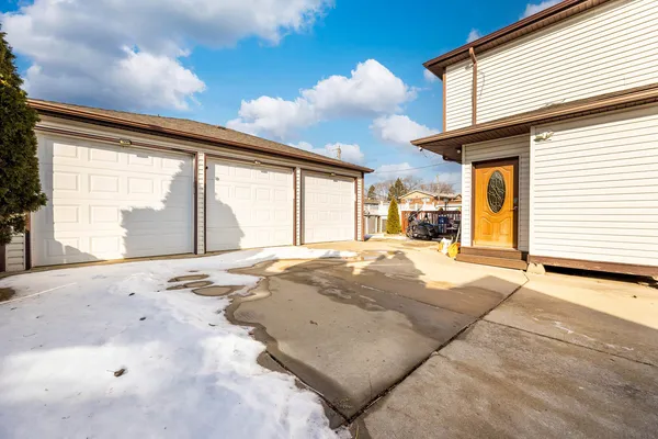 a view of a house with a backyard and a garage
