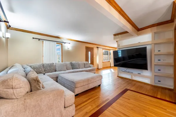 a living room with couches and a flat screen tv