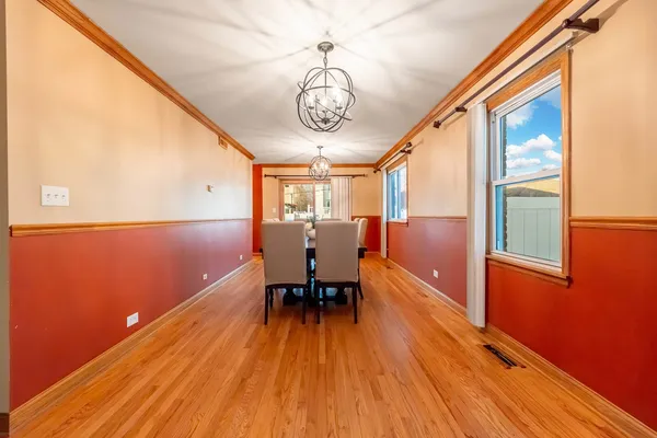 a view of a room with wooden floor and furniture