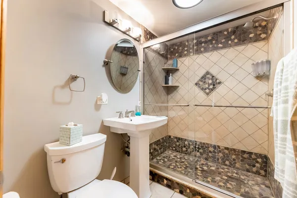 a bathroom with a sink toilet and shower