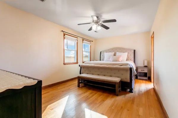 a bedroom with a bed and wooden floor
