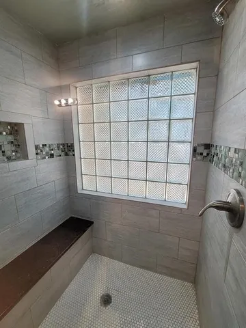 a bathroom with a bathtub and shower
