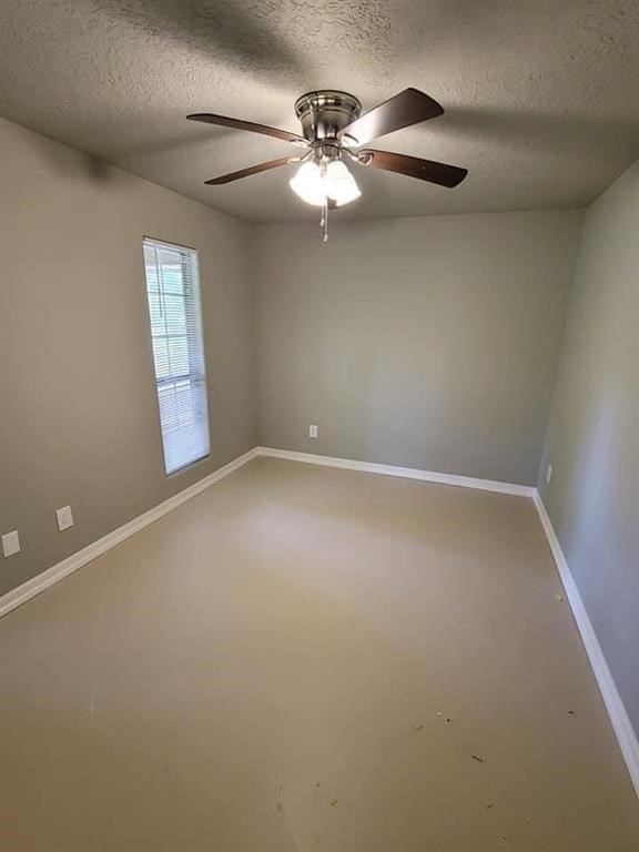 123 Pinehurst Drive Sour Lake, TX 77659 - Photo 16 of 23 an empty room with windows and fan