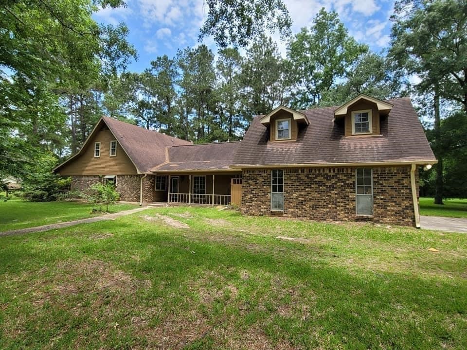 123 Pinehurst Drive Sour Lake, TX 77659 - Photo 21 of 23 a front view of a house with a garden