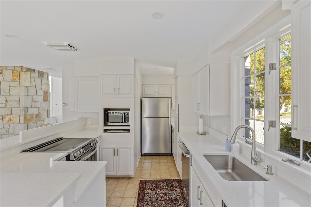 89 Naugus Avenue Marblehead, MA 01945 - Photo 16 of 39 a kitchen with stainless steel appliances granite countertop a sink and a refrigerator