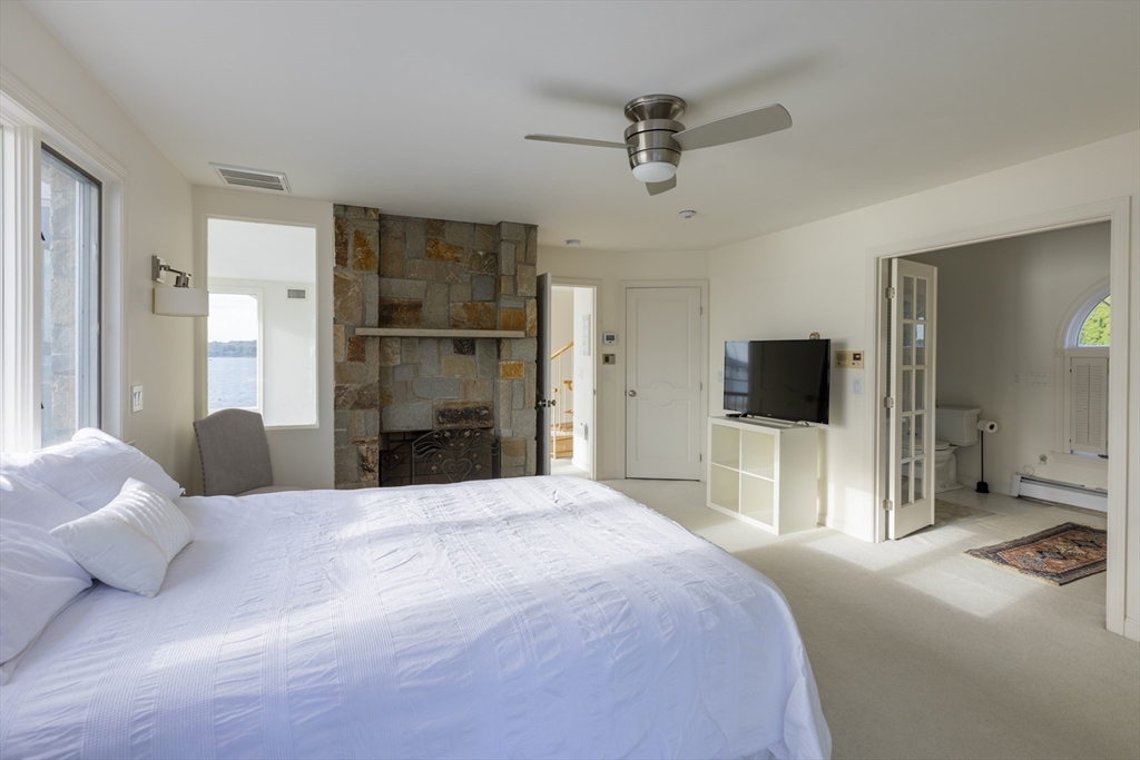 89 Naugus Avenue Marblehead, MA 01945 - Photo 20 of 39 a bedroom with a bed and a flat screen tv