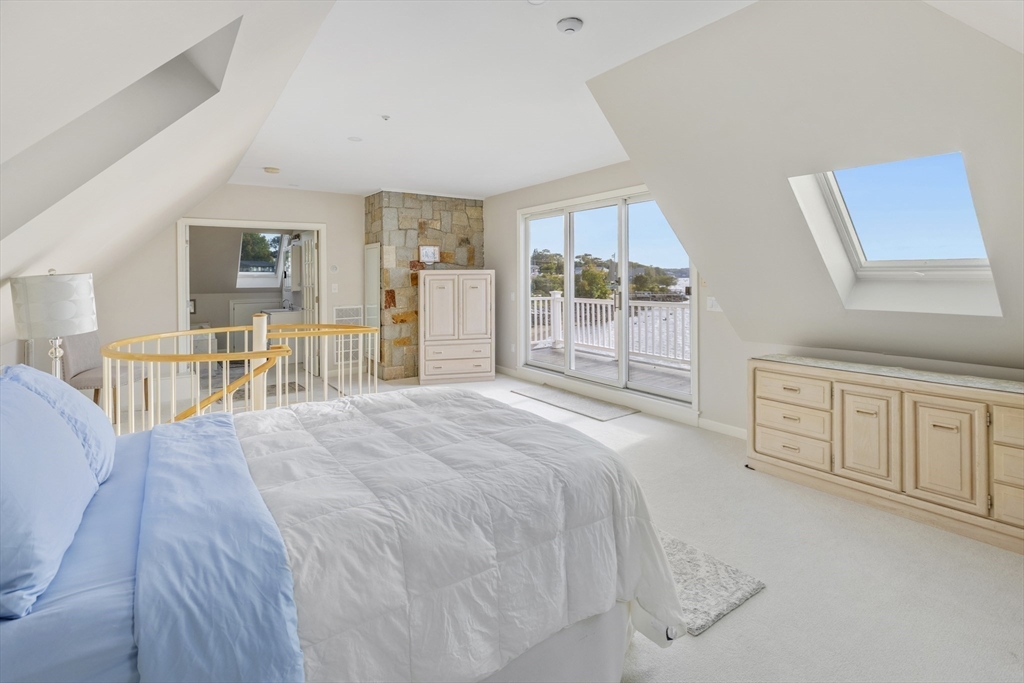 89 Naugus Avenue Marblehead, MA 01945 - Photo 21 of 39 a spacious bedroom with a bed a dresser and a large mirror