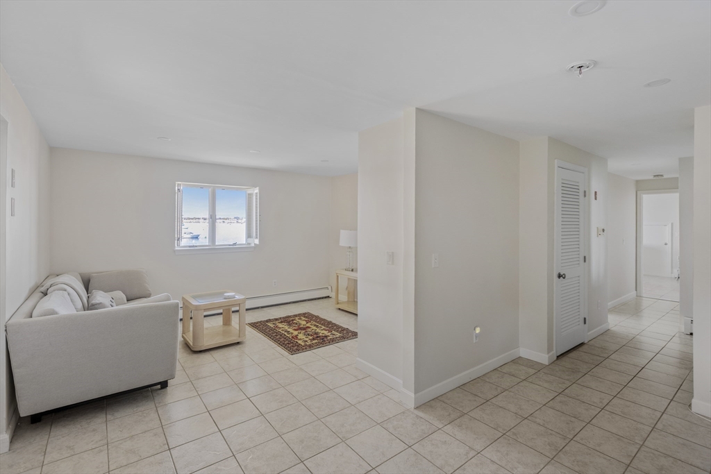 89 Naugus Avenue Marblehead, MA 01945 - Photo 23 of 39 a living room with furniture and a couch
