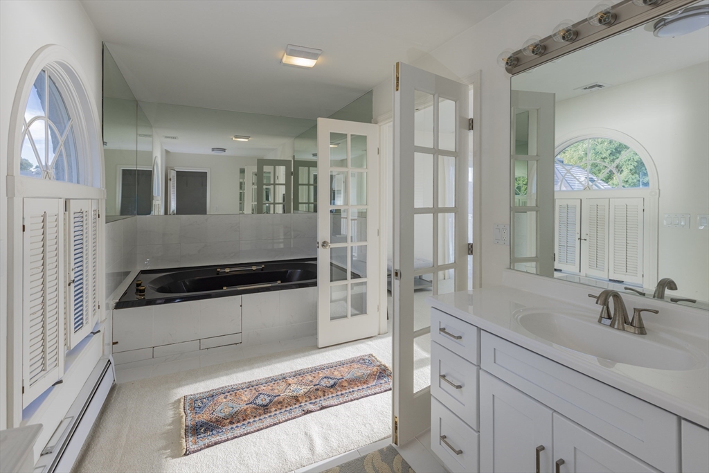 89 Naugus Avenue Marblehead, MA 01945 - Photo 26 of 39 a bathroom with a sink and a mirror
