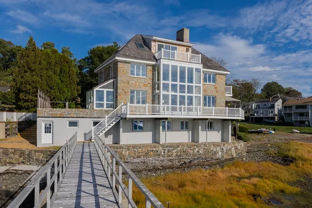 a front view of a house with a garden and yard