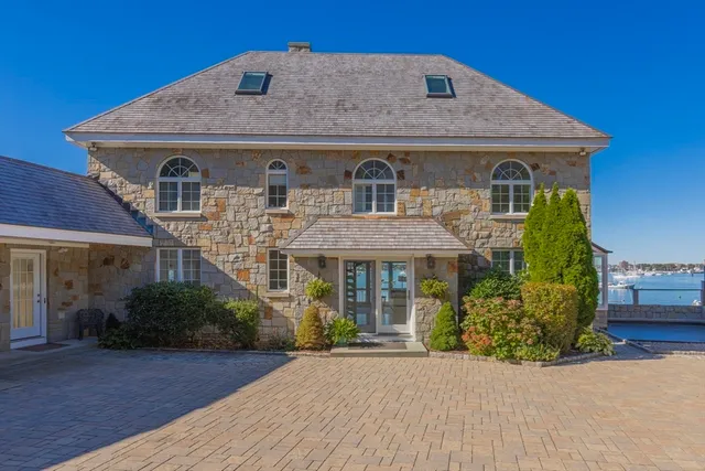 a view of a lake with lawn chairs