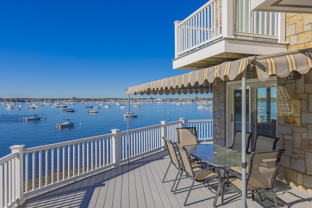 89 Naugus Avenue Marblehead, MA 01945 - Photo 34 of 39 a view of a roof deck with table and chairs