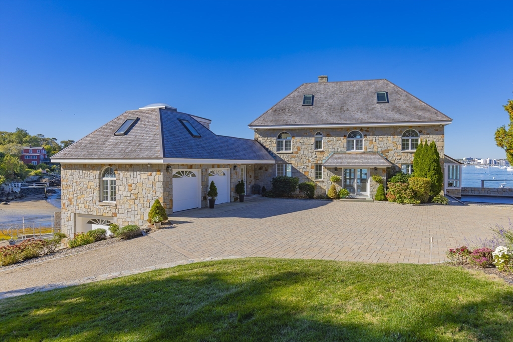 89 Naugus Avenue Marblehead, MA 01945 - Photo 4 of 39 a front view of a house with a garden and yard