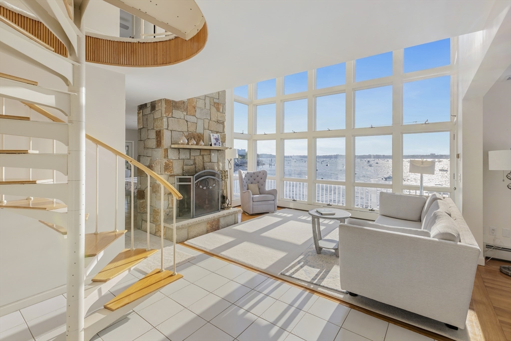 89 Naugus Avenue Marblehead, MA 01945 - Photo 5 of 39 a living room with furniture and a floor to ceiling window