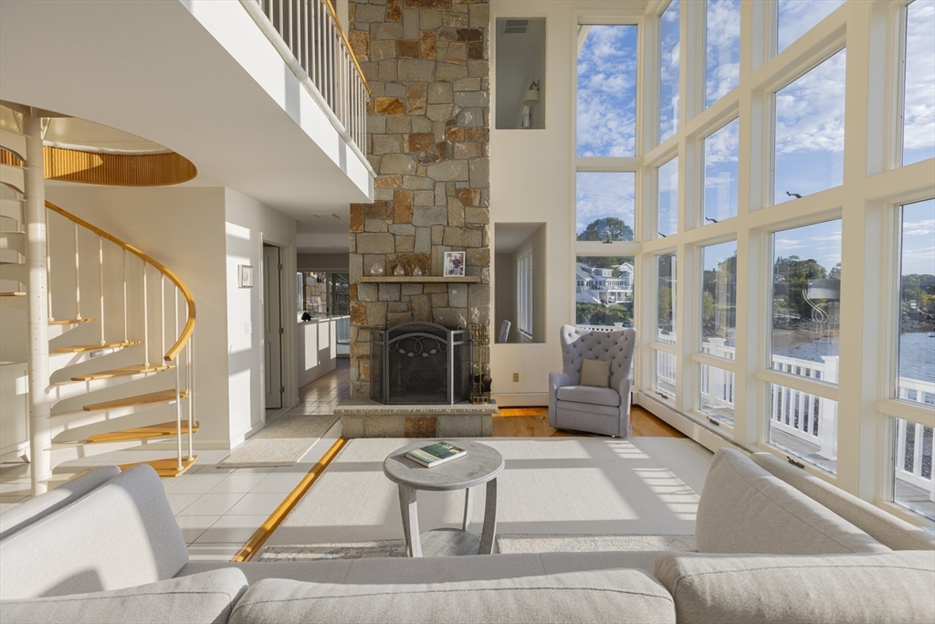 89 Naugus Avenue Marblehead, MA 01945 - Photo 7 of 39 a living room with fireplace furniture and a floor to ceiling window
