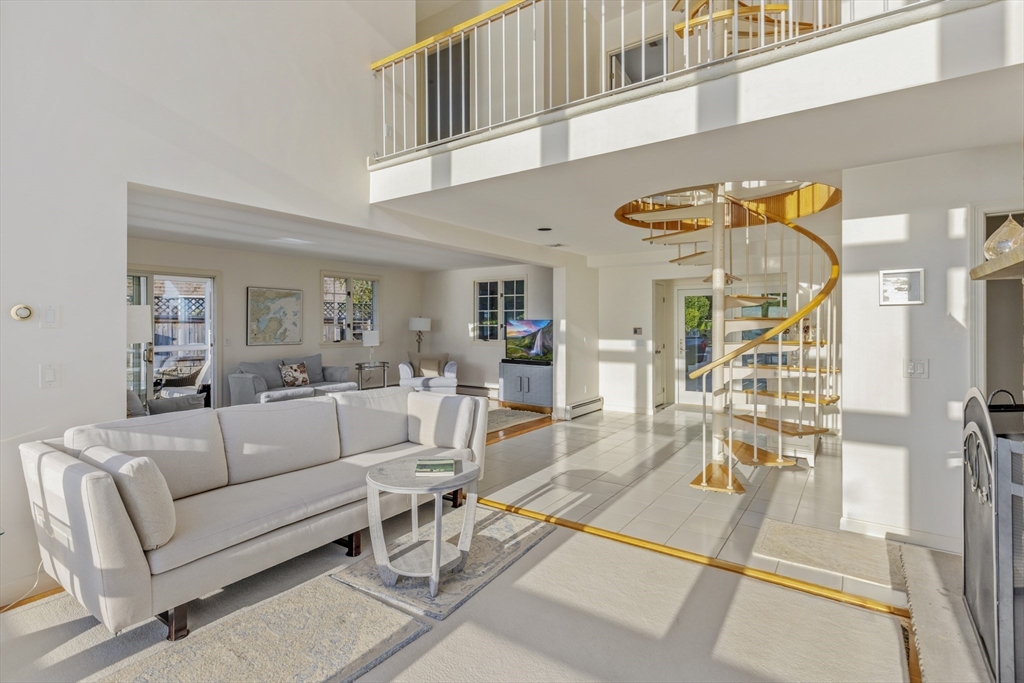 89 Naugus Avenue Marblehead, MA 01945 - Photo 9 of 39 a living room with furniture and a chandelier