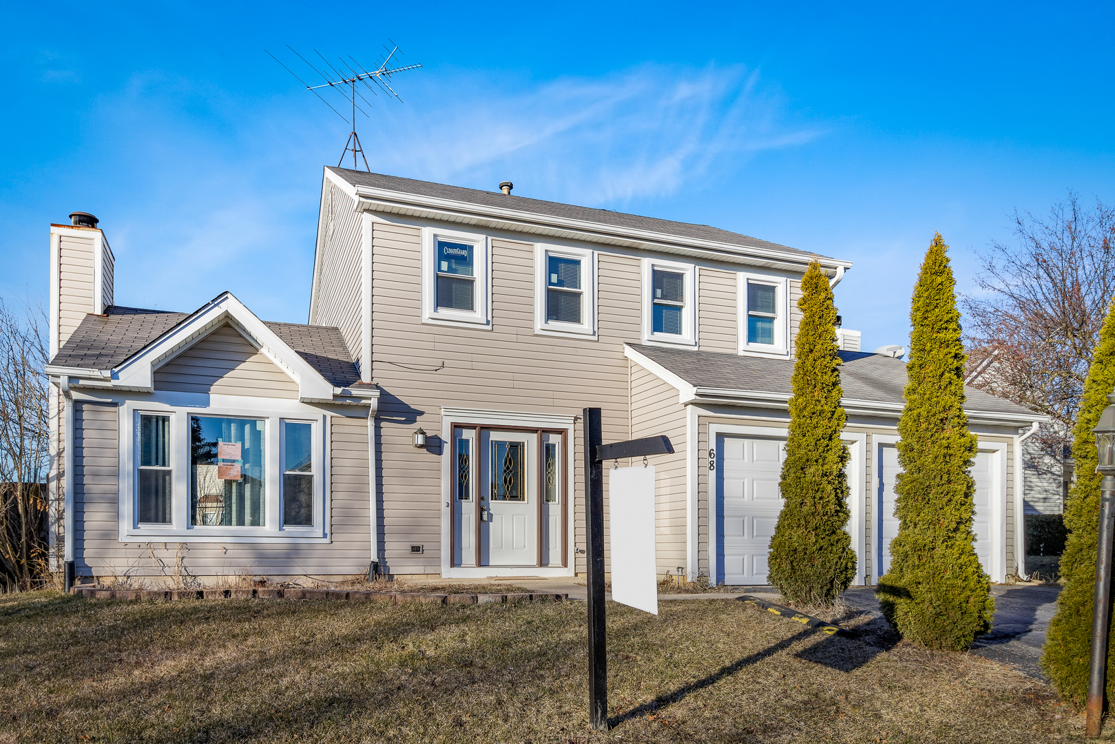 68 Jackson Lane Streamwood, IL 60107 - Photo 1 of 25 a front view of a house with a yard