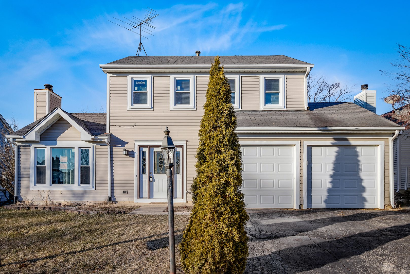 68 Jackson Lane Streamwood, IL 60107 - Photo 2 of 25 a view of a white house with large windows and a yard