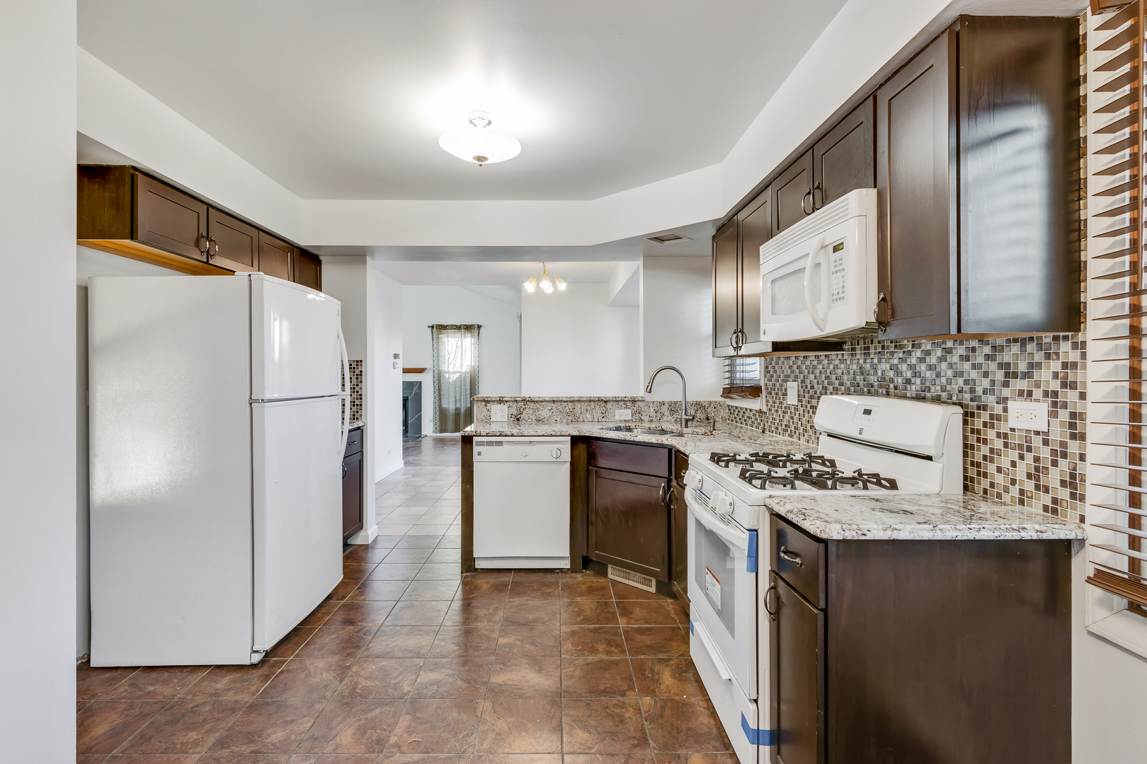 68 Jackson Lane Streamwood, IL 60107 - Photo 11 of 25 a kitchen with a refrigerator and a sink