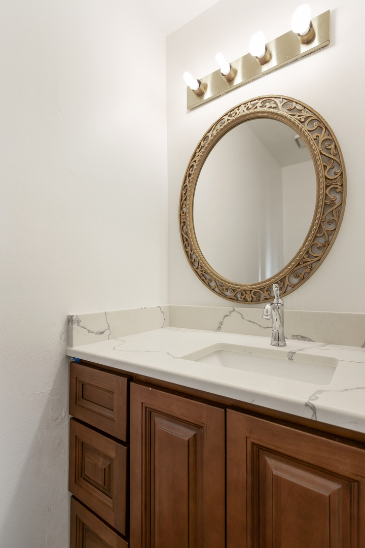 68 Jackson Lane Streamwood, IL 60107 - Photo 12 of 25 a bathroom with a sink and a mirror