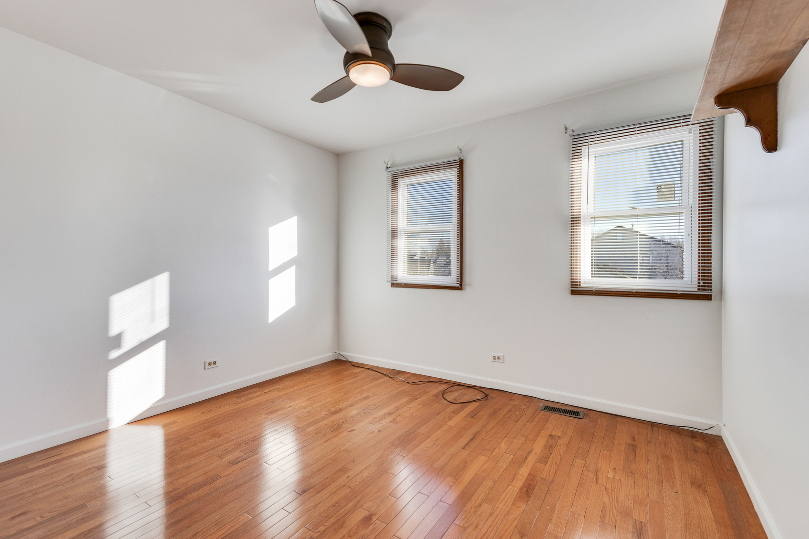 68 Jackson Lane Streamwood, IL 60107 - Photo 19 of 25 a view of empty room with wooden floor and fan