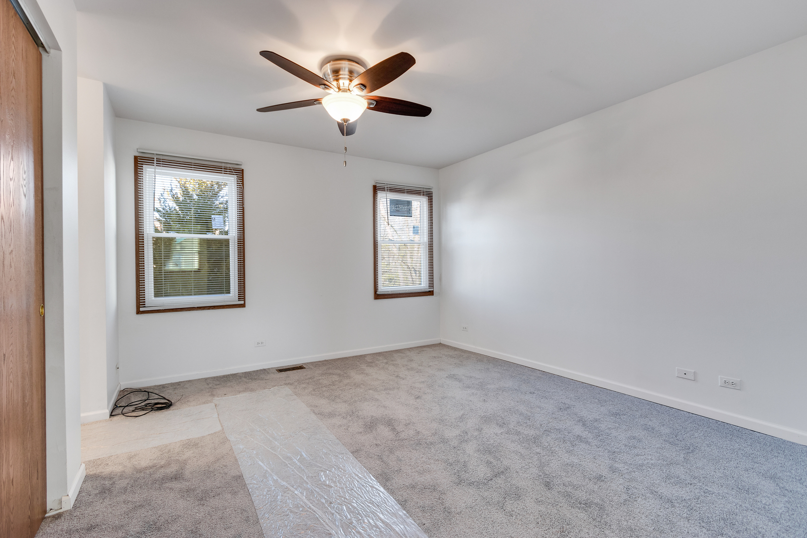 68 Jackson Lane Streamwood, IL 60107 - Photo 20 of 25 an empty room with windows and ceiling fan