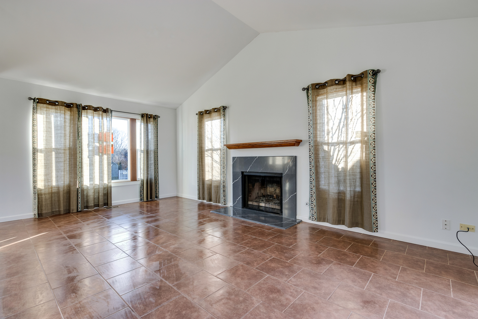68 Jackson Lane Streamwood, IL 60107 - Photo 5 of 25 an empty room with windows and fireplace