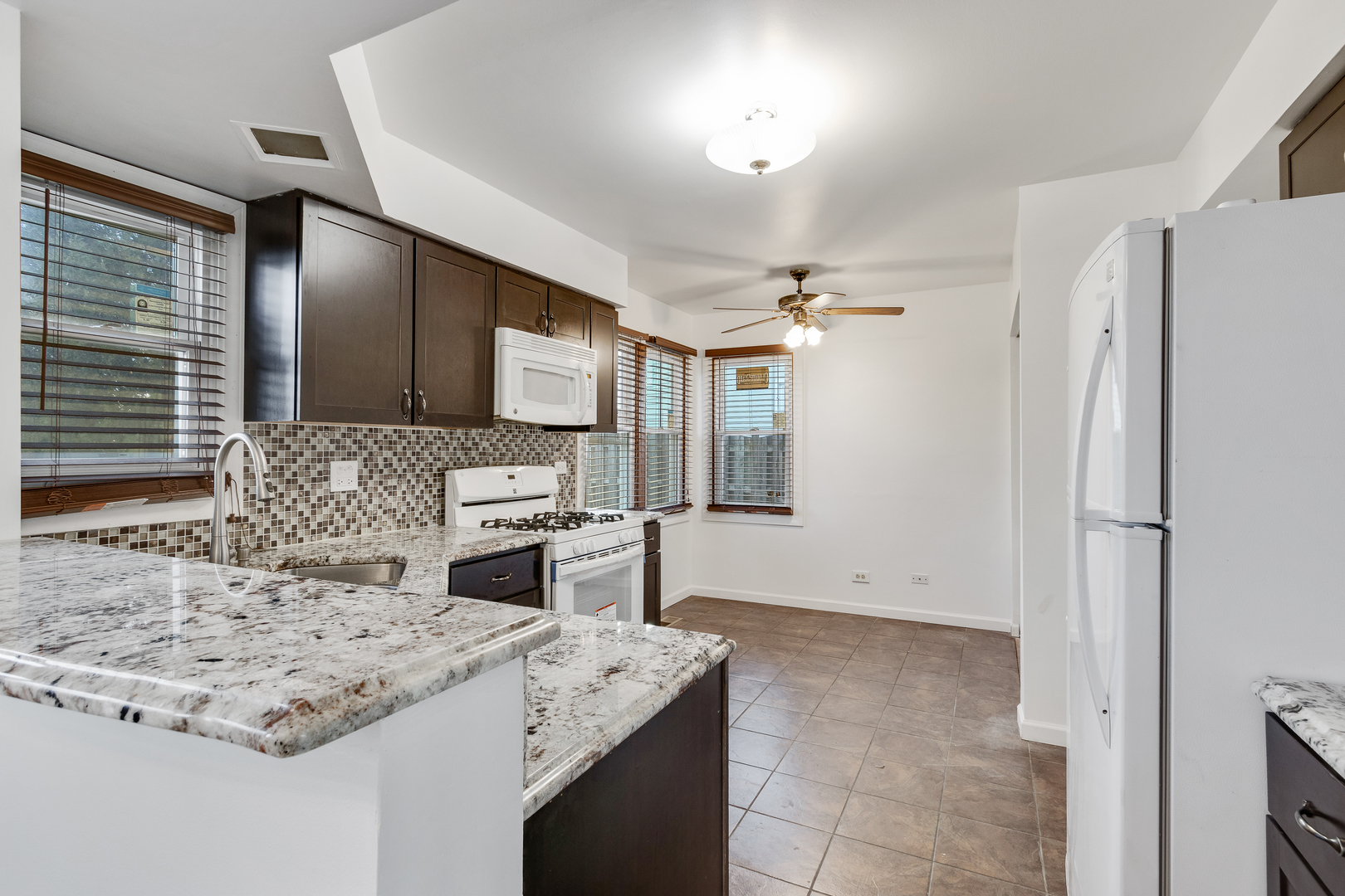 68 Jackson Lane Streamwood, IL 60107 - Photo 9 of 25 a kitchen with stainless steel appliances granite countertop a sink stove and refrigerator